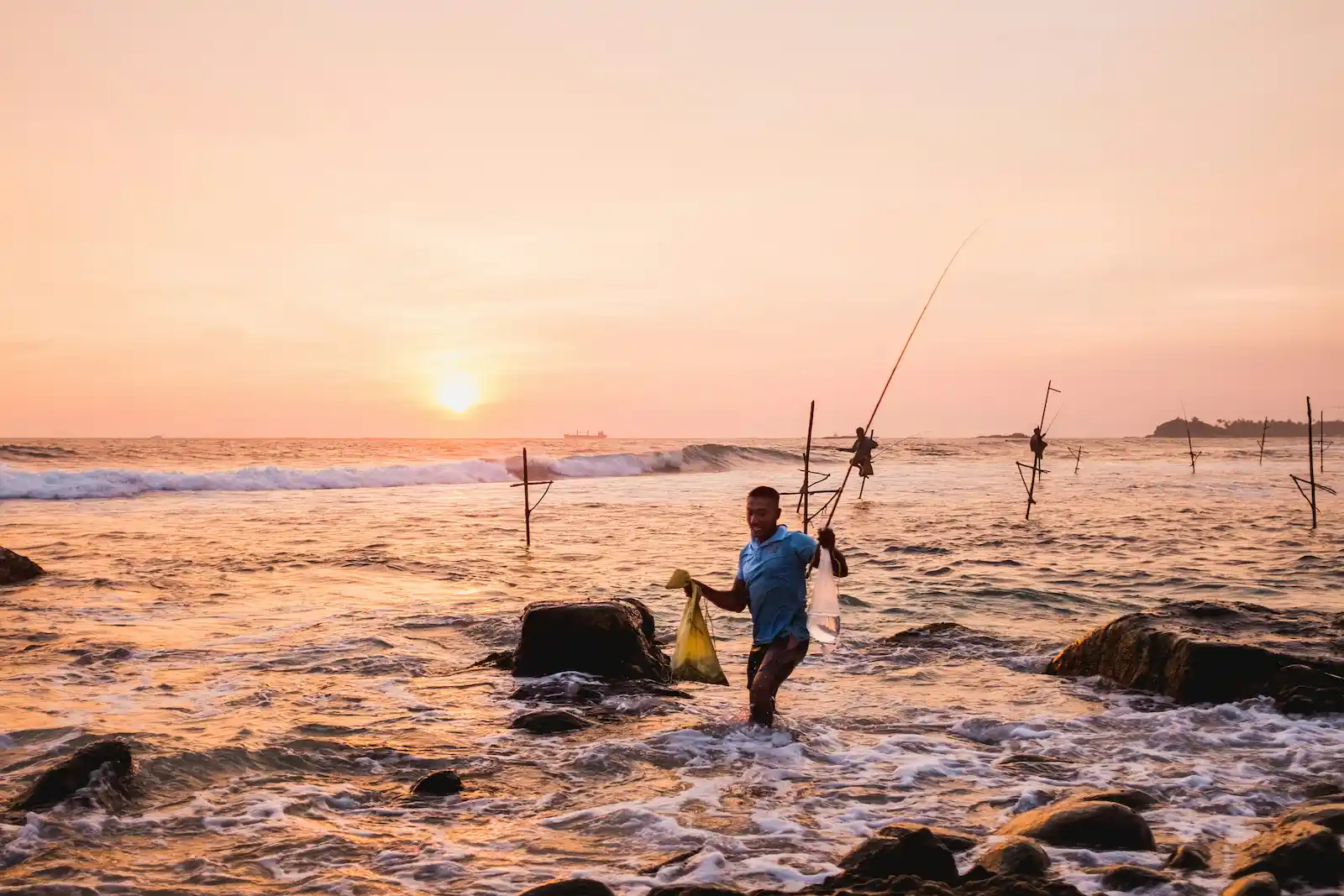 Stilt fishermen at sunset near Unawatuna, Sri Lanka